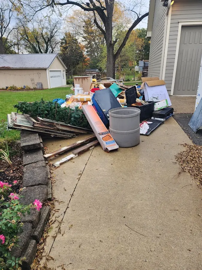Dumpster being loaded with debris for Demolition Dumpster Rental in Garden City